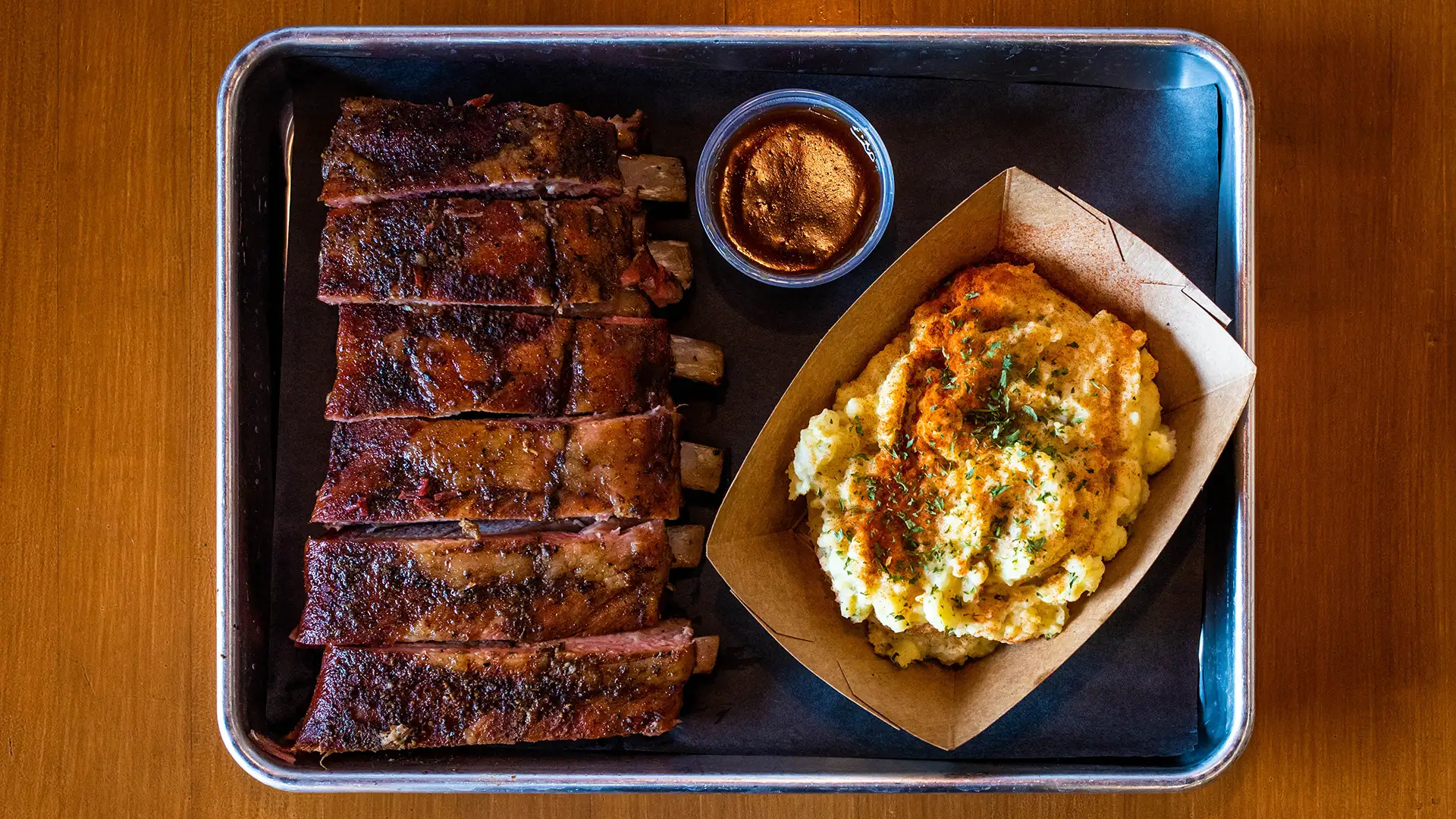 Plate with ribs and a side of potatoes